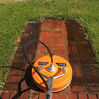 photo of an in process cleaning on a red brick sidewalk